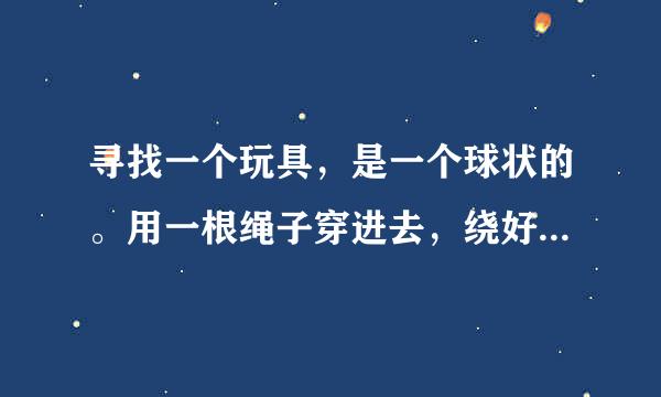 寻找一个玩具，是一个球状的。用一根绳子穿进去，绕好后，双手需要一起摇一下，然后一拉，一放就可以旋转